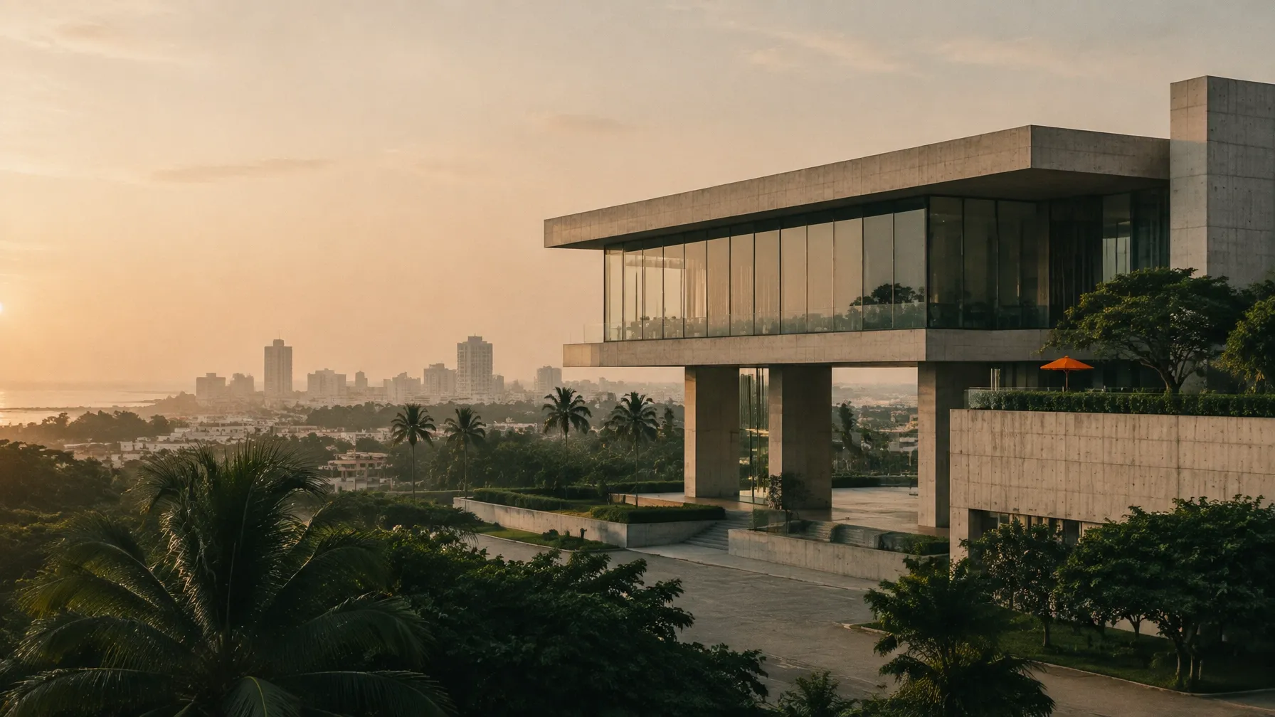 Modern African business headquarters overlooking a coastal city at golden hour